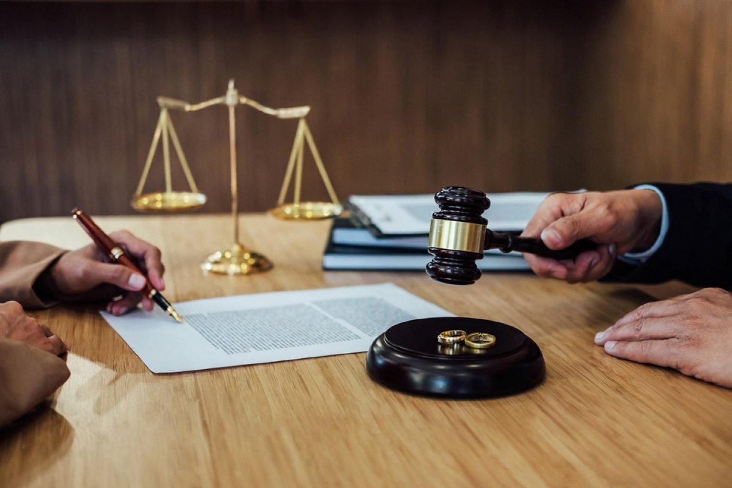 Lawyer and client meeting at a desk with gavel and scales of justice, representing criminal defence in Dubai
